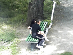 Russian lovers kiss and caress each other in the city park
