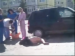Drunken girl lies on the road with her ass naked