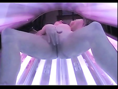 Masturbating amateur in a tanning bed