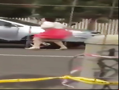 Crazy woman undresses in the middle of the street